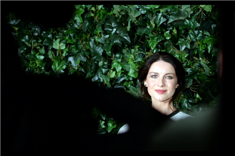 I don't know who she is. Also, I don't know what the species of plant behind her is, and I don't even know how many paparazzi elbows I'm shooting through in this photo... (Edited to add : Irish actress Caitriona Balfe)