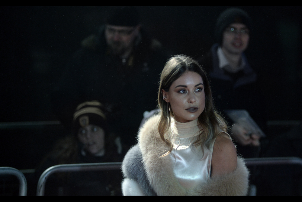 I don't know who this is, but the three very different expressions on the faces of the people behind me make me even more intrigued than I'd normally be.