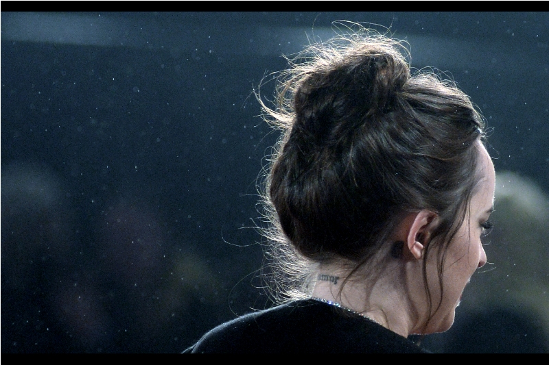 Although they could as easily be hieroglyphs, cyrillic or a radical new numbering system being devised by Security for upcoming premieres, it seems that the tattoo on the back of Dakota Johnson's neck reads "bmor". Not sure that's helpful, but you're welcome.