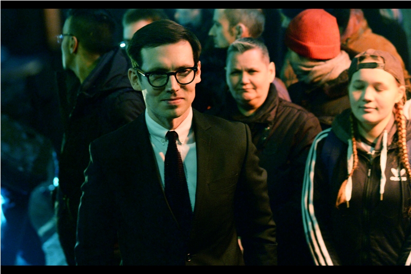 Some kind of fashion designer? Glasses Model? Rogue Accountant? (edited to add : he's Erdem Moralioglu, which is a name so awesome I refuse to do more research on who it belongs to)