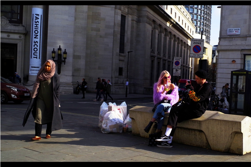 "If you move back closer to that bit of street garbage, my photo will make a statement about something really profound. That'll make it Fashion AND Art, baby" (or fART for short, and yes damnit I'm copyrighting that)