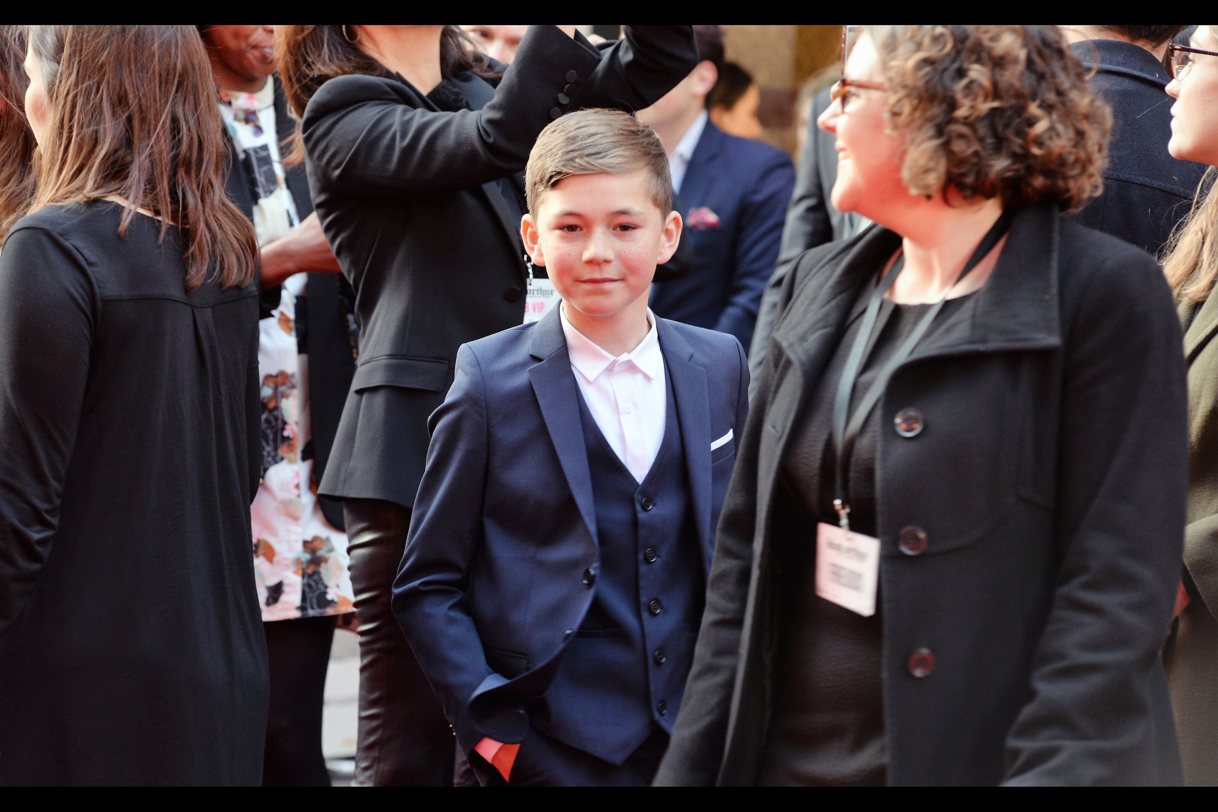 I think this is Hugh Robb, who plays the role of Arthur (age 11) in the film, which also has actors playing him at ages 2, 6, 19, and 'age of Charlie Hunnam'. Edited to add : Correction : he's Bleu Landau, who is from Eastenders, and who is also in this film - with thanks to Jason Archer!