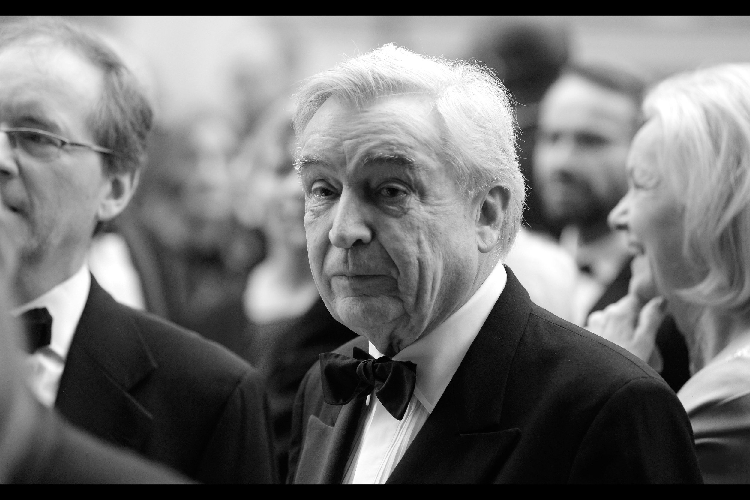 The face of this man looks at me and says : "Young man, why are you wasting the last vestiges of the youth you still have photographing this event; and don't you think you should wear a bow tie more often?" And it grieves me that I have nothing to say in reply to the face of that man.