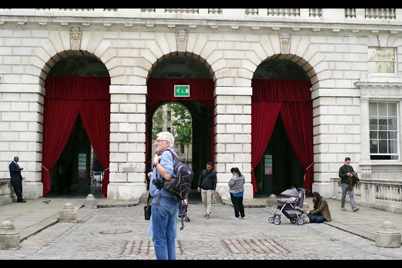 To make people feel special, Somerset House installed snazzy-looking red curtains at the north entrance of the open air cinema. And for no charge, American Tourists will stand right in front of your photo for longer than you could possibly imagine, just looking at a board to the left.