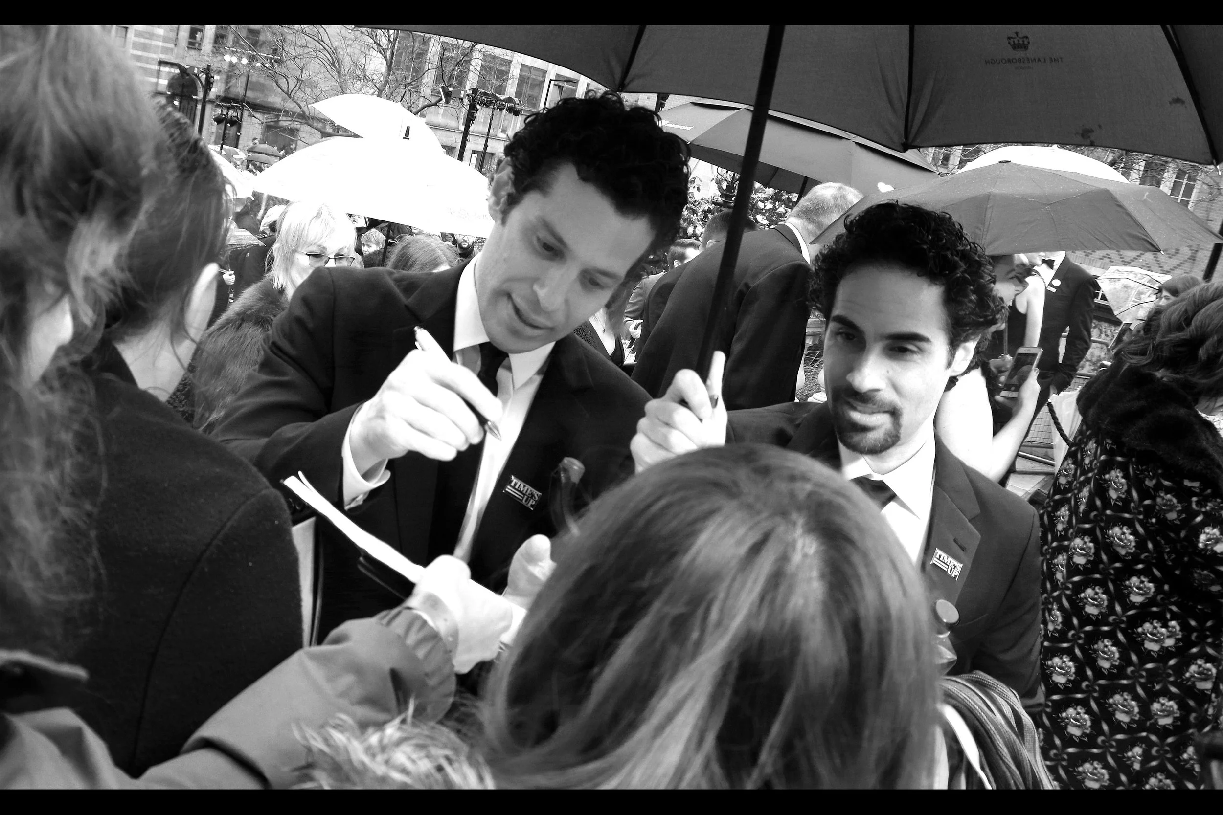 "Okay, you sign as me and I'll sign as you" . The Italians in front of me sometimes seem happy just to be in proximity to famous (?) theatre people - they'd probably accept this compromise. (Also : I don't know who they are)