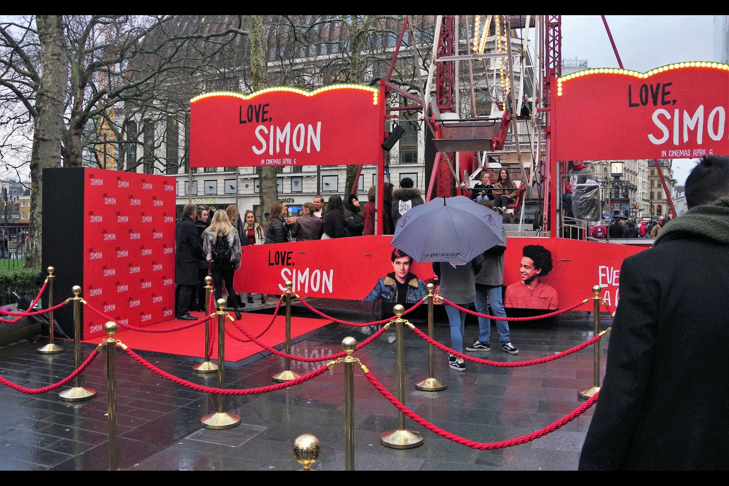 I think might have seen a Dealer Rat walk past the ferris wheel, sniff with disinterest and keep walking... but I can report the presence of a small patch of RED CARPET at this event!! AND rope barriers!! And a posing board!! Hey, don't laugh - this is already a better event than the public elements of the European Premiere of Black Panther .