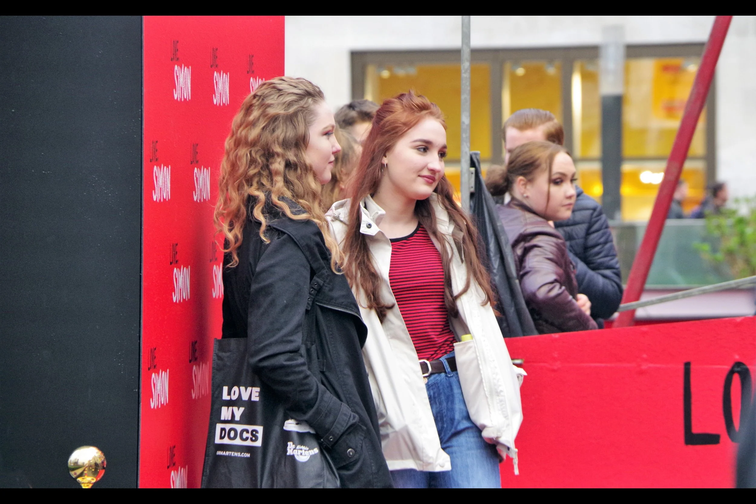 She almost certainly isn't, but isn't there a possibility this is the redheaded girl on the poster? Enough so that I can announce that either a star from the film (or an officially sanctioned lookalike) has shown up at the premiere? (And stood in front of the posterboard with no paparazzi there to photograph her?)