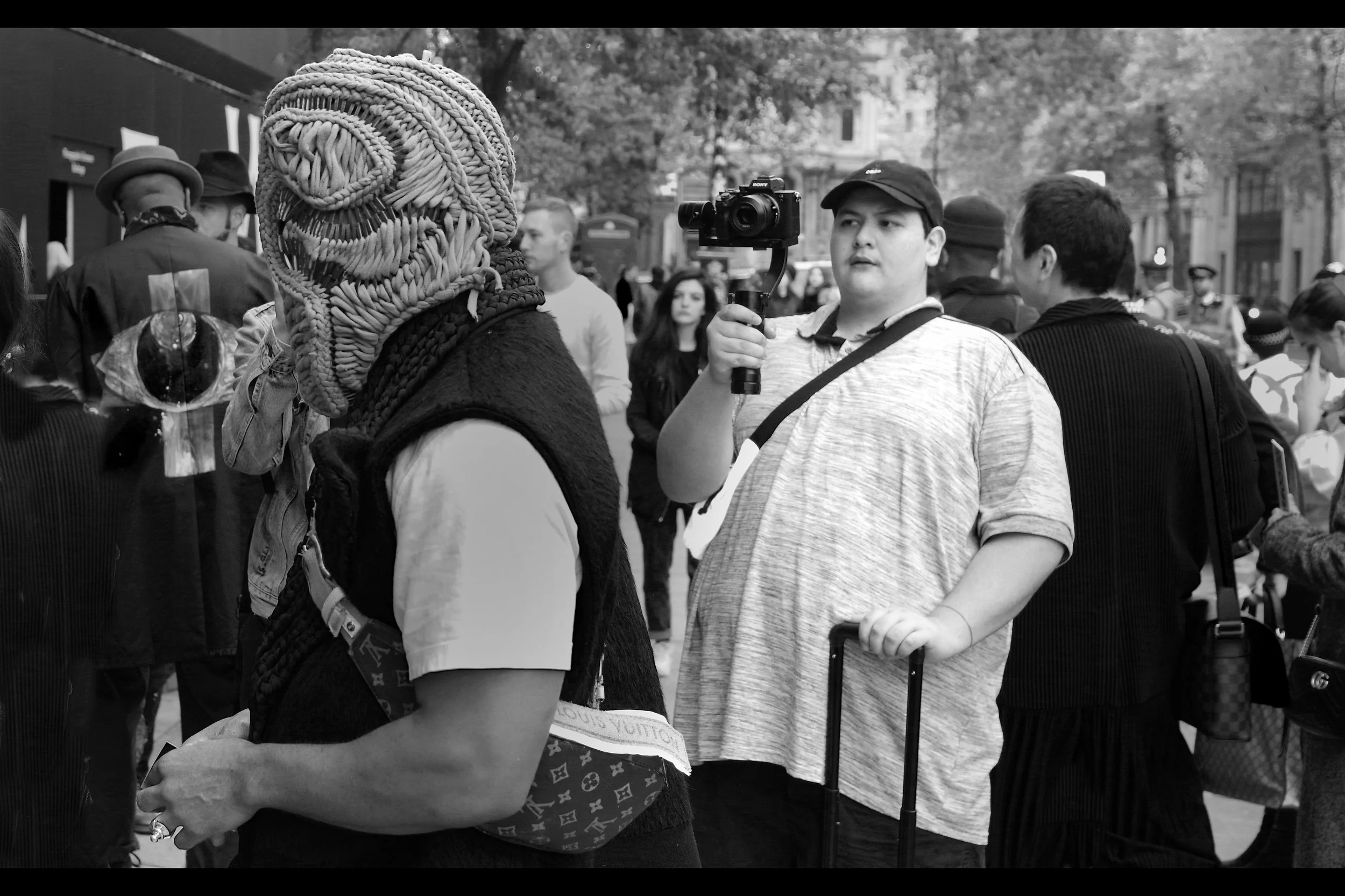 “Nah, bro. I totally dig your ‘art’. Doesn’t intimidate me one bit” By the way, for those of you running your own sweatshop operations at home, that head-covering the guy is wearing goes ALL the way around the head. I did not see any evidence of eye-holes.