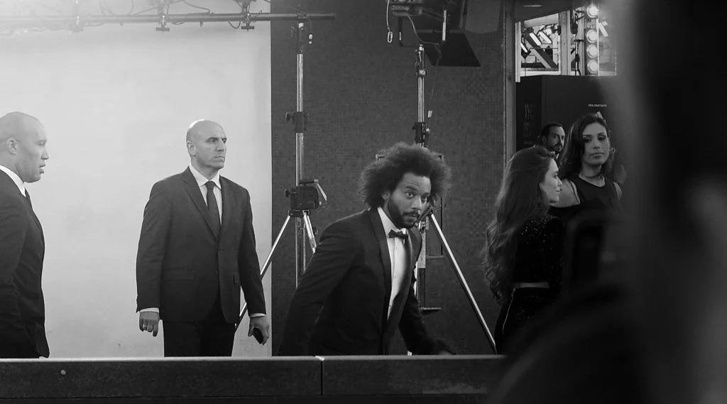 Edited to to add : I (still) don’t know who this is. But as pointed out : white trainers, black tuxedo. Nice.