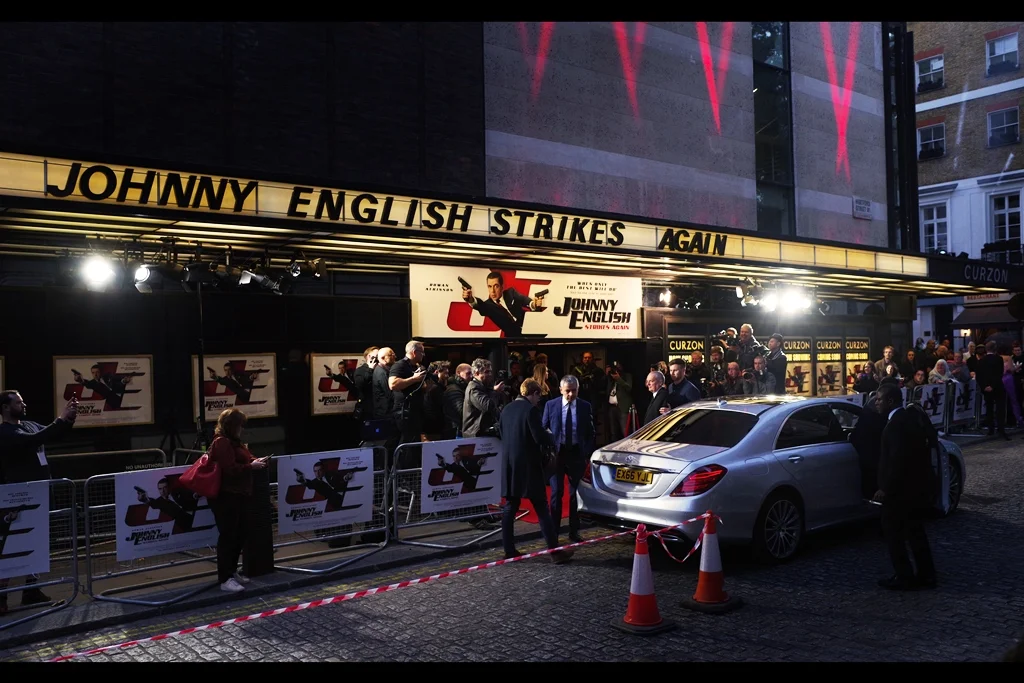 Rowan Atkinson arrives and sees the impenetrable wall of doom that two traffic cones and some plastic tape represents, and decides coming across to our side of the road is not worth the risk. (He then does, signs maybe two autographs,and retreats)