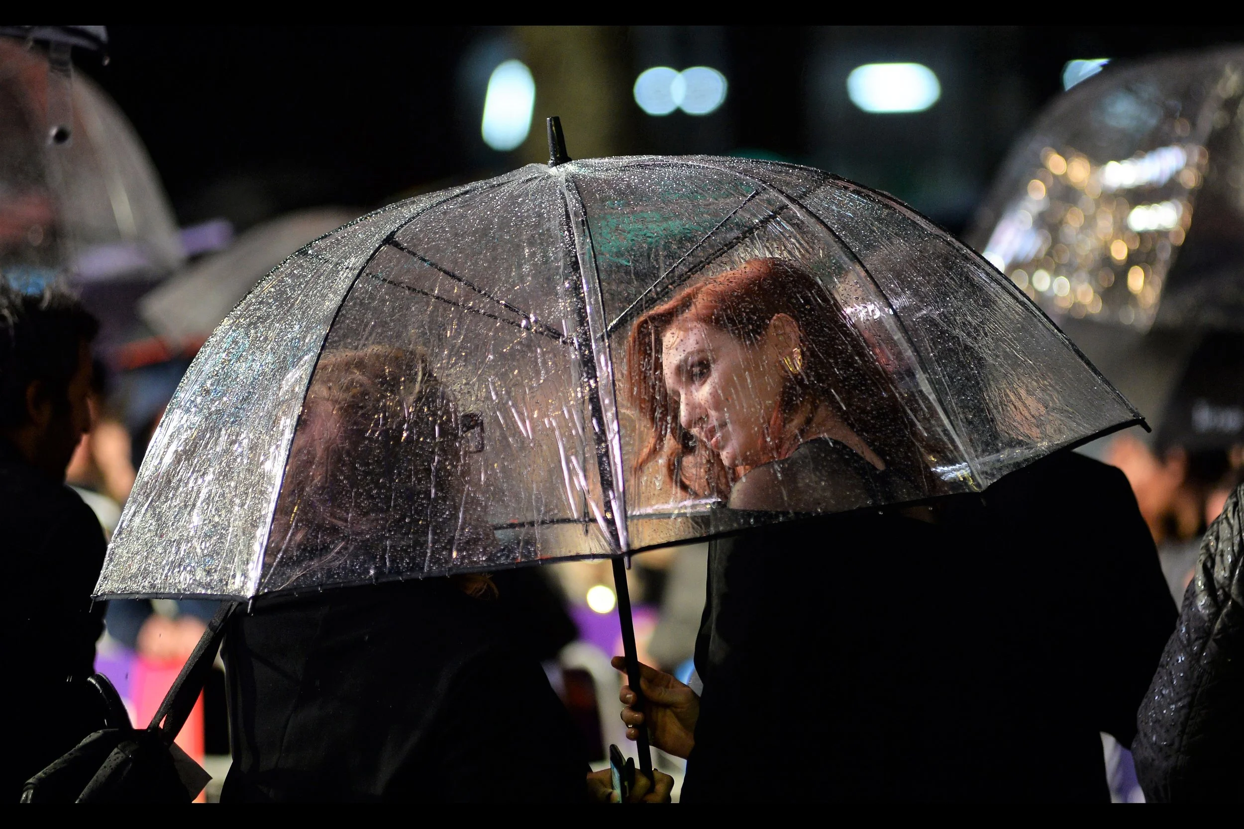 I’d love to say that me taking photos of people chatting through umbrellas is an expression of my joy at using the mighty Nikon D4 and its superior autofocus in low light, but mostly it’s an expression of the realisation that I’m in a f**king terrible spot, off-carpet, where I will have no view of anyone ON the carpet, and I did all this because… well… you know how alcohol makes you do insane things while thinking they’re genius? Well I did that… but without drinking any alcohol.