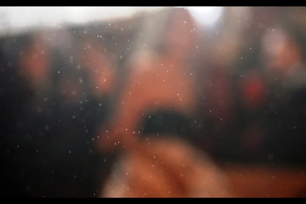 Just to make things more challenging : the front element of the Nikon is now so waterlogged that it’s focussing on the raindrops rather than the people in front of it. I’d wipe it with something dry, but not much that I’m wearing constitutes “something dry” right now.