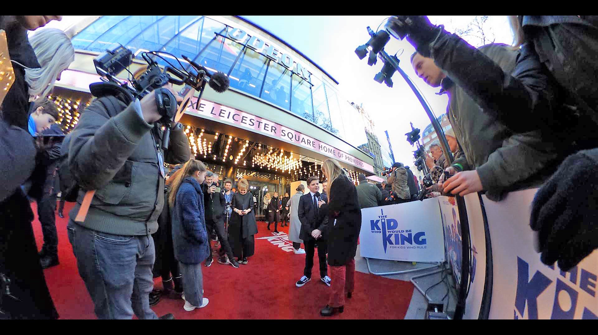 I’m using the quirky 360 degree Ricoh Theta on this shot, not just because I like it as a gimmick, but because I’ve noted that, just like any proud father, Andy Serkis has angled himself in front of the paparazzi cordon to photograph his son being interviewed by Edith Bowman.