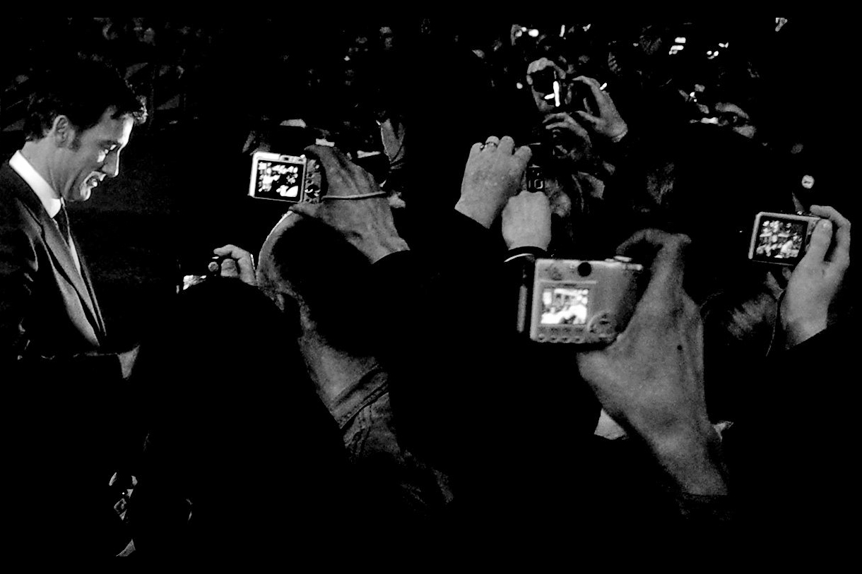 Clive Owen poses for disembodied hands holding cameras, in a photo I call "Diligence"