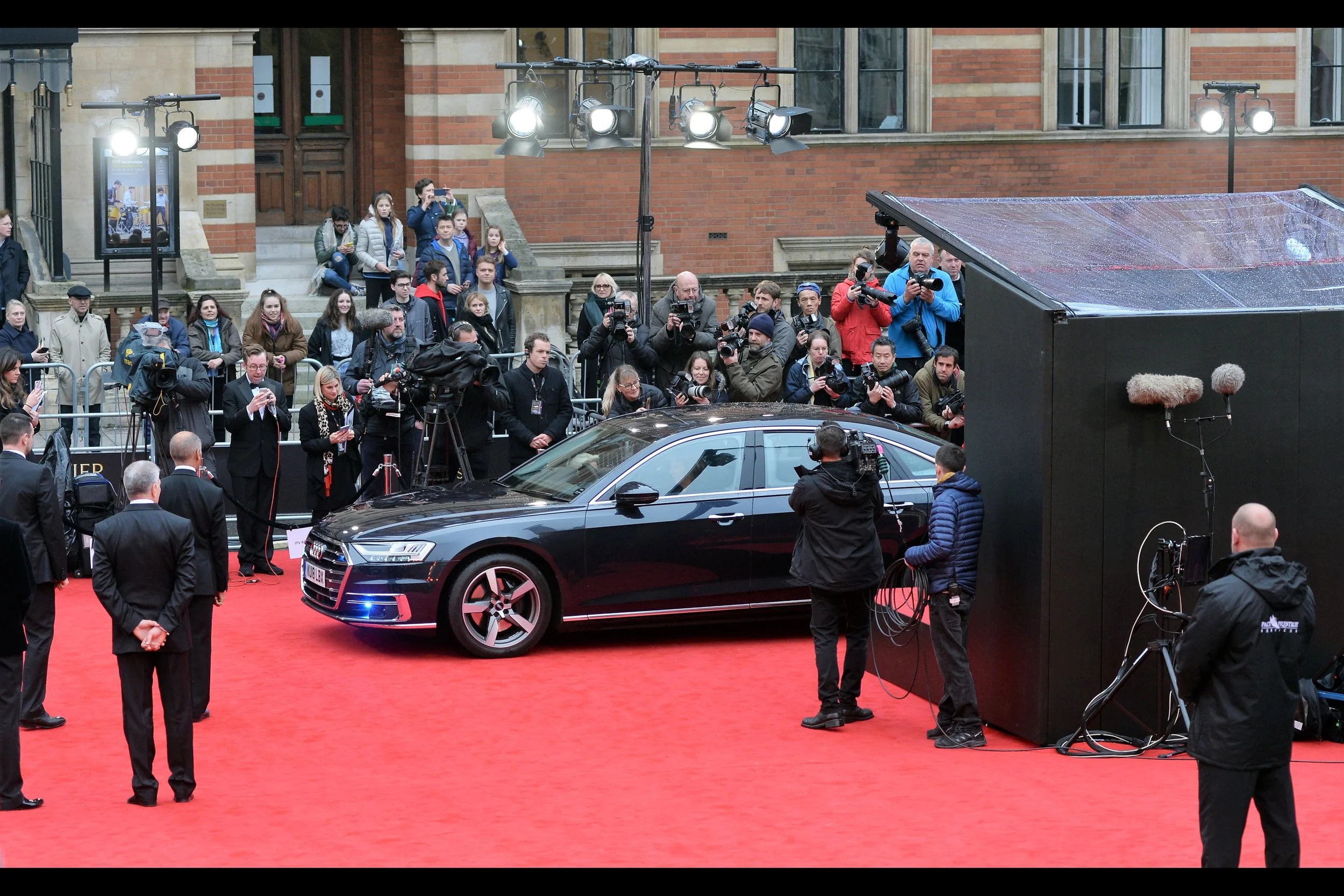The carpet is cleared and a car pulls up. And if its occupant doesn’t have a ticket to the event this could all be rather awkward. Though the armed dudes on motorcycles could probably clear things up pretty quickly.