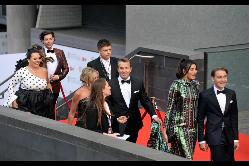 I don’t know who a single person in this photo is, but I can confirm that the lady in the back in the polka-dotted top walked past several times for reasons it’s far too late in the evening (half past midnight) to speculate upon. (lady later identified as : Scarlett Moffatt)