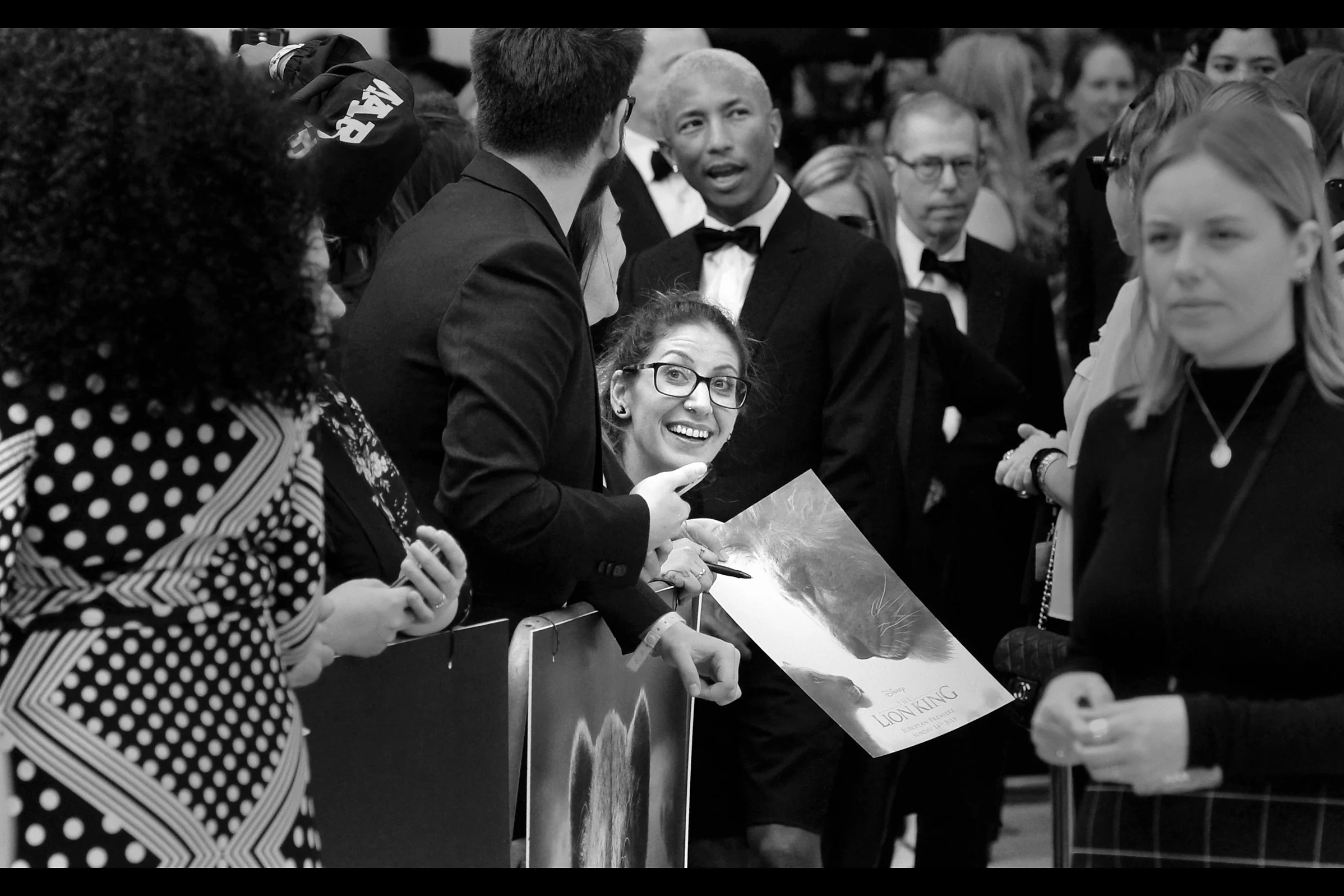 “Is that lady photobombing me? Damnit… I’m wearing SHORTS especially at this premiere” - behind the smiling lady is 13-time-Grammy Winner Pharell Williams, who produced several songs for the soundtrack of this movie (or I’m guessing ‘variants of songs from the original’?)