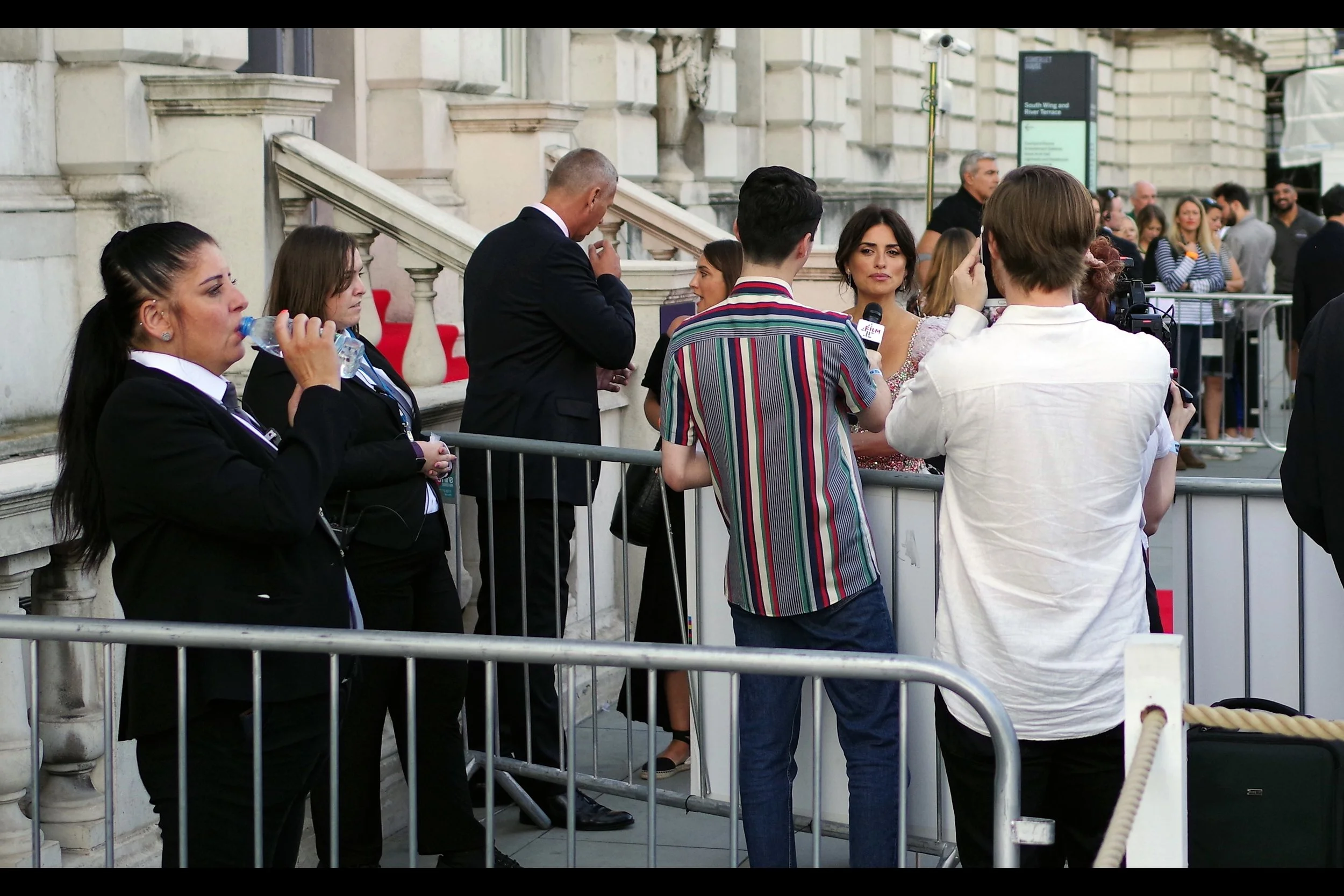 Penelope Cruz, like Pedro Almodovar, has an Academy Award to her name. But there’s a rope barrier, two metal barriers, two Security and at least one guy with a fetching vertically-striped shirt between us. Regrettably, while I’m on two pints of the Amber Liquid and may have just enough confidence that stupid ideas work, I’m probably not physically nimble enough to carry them out.