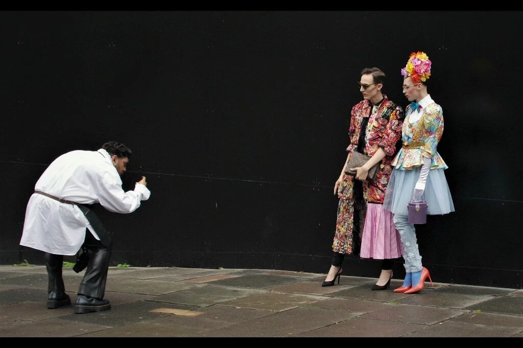 “Gregor, far be it from me to question in what backwater rural village you learned about fashion or photography, or got your camera from…. but I’m looking stunning and he’s looking somewhat adequate, and what exactly are you pointing your camera at?”