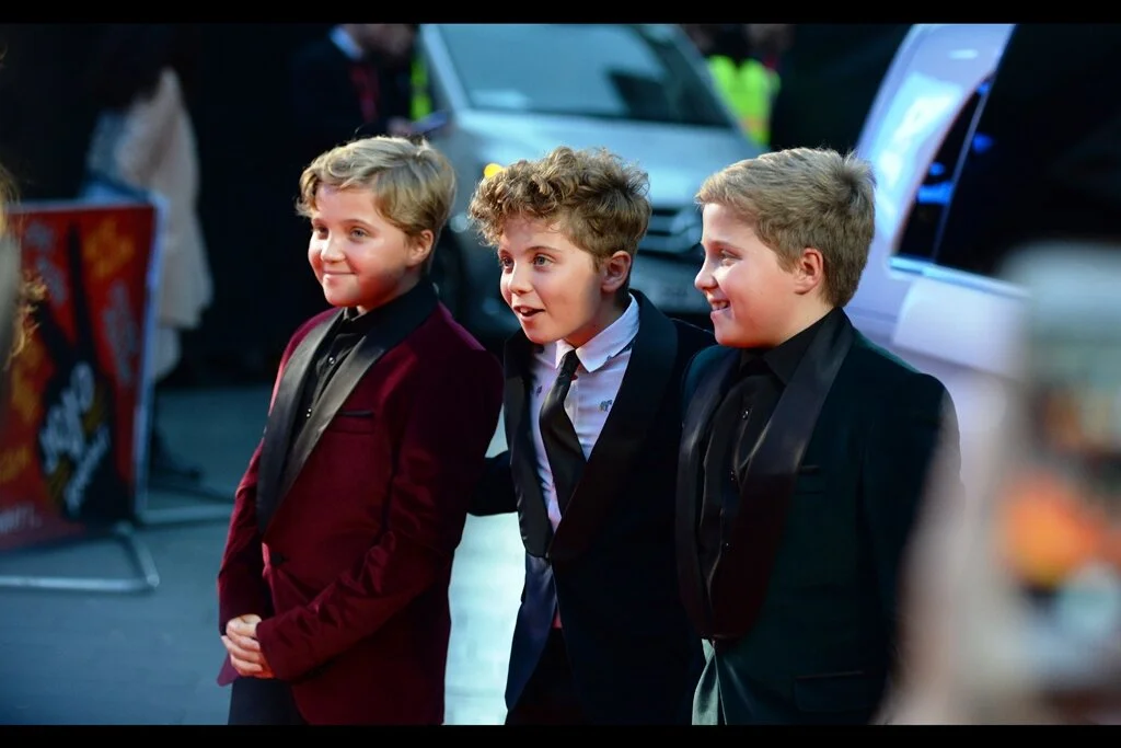 Roman Griffin-Davis poses with his two twin brothers… though the fact that none of them are putting bunny rabbits above each others’ heads when being photographed by the press just feels kind of… un-brotherly.