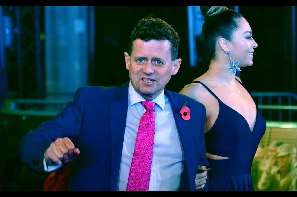 Mike Bushell, and Mike Bushell’s tie, and Mike Bushell’s uncertainty at being photographed (and/or Mike Bushell’s rising right fist at being photographed).