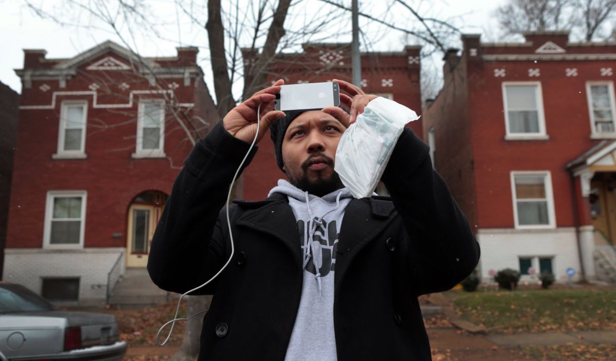 Activist Charles Wade of Austin, Texas, and Operation Help or Hush, photographs apartments in Dutchtown on Thursday, Dec. 18, 2014. Wade is starting to move protesters from motels to transitional housing subsidized by the organization. Photo by Robert Cohen, rcohen@post-dispatch.com