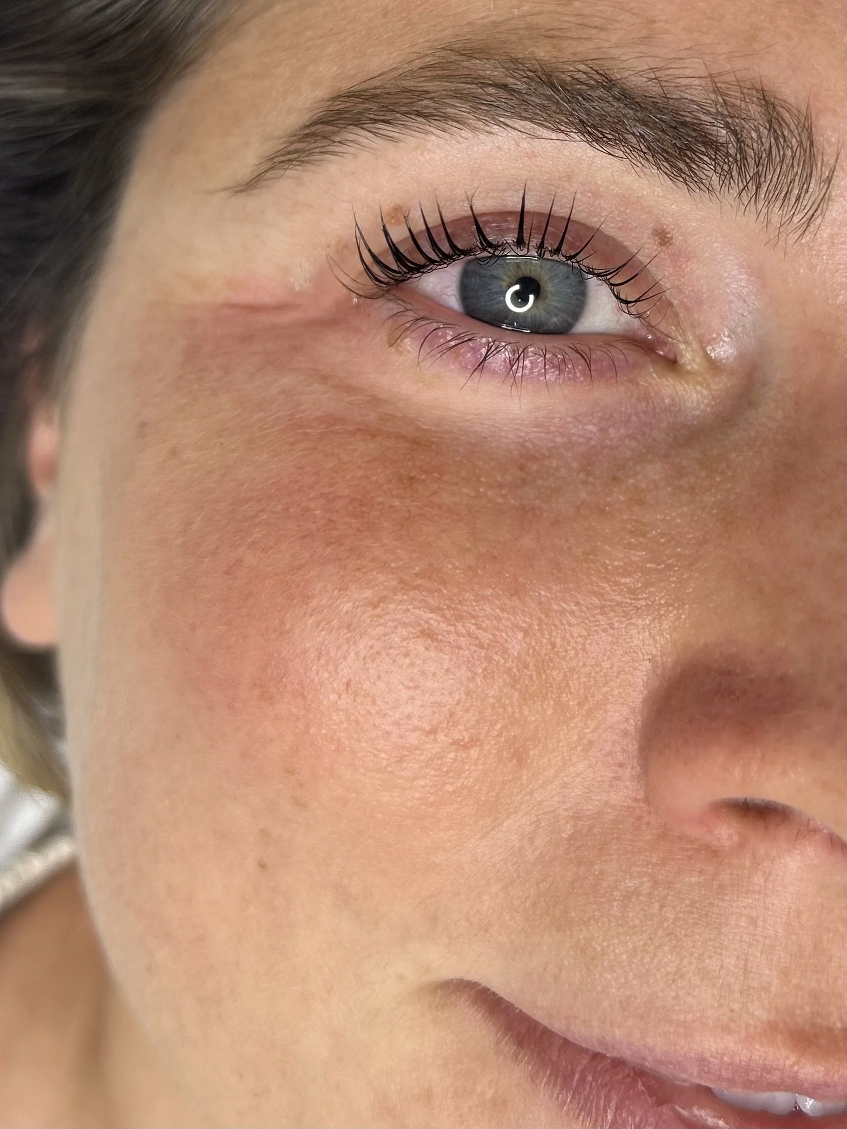 Close-up of a woman's face showing her lash LVL Nouveau treatment.