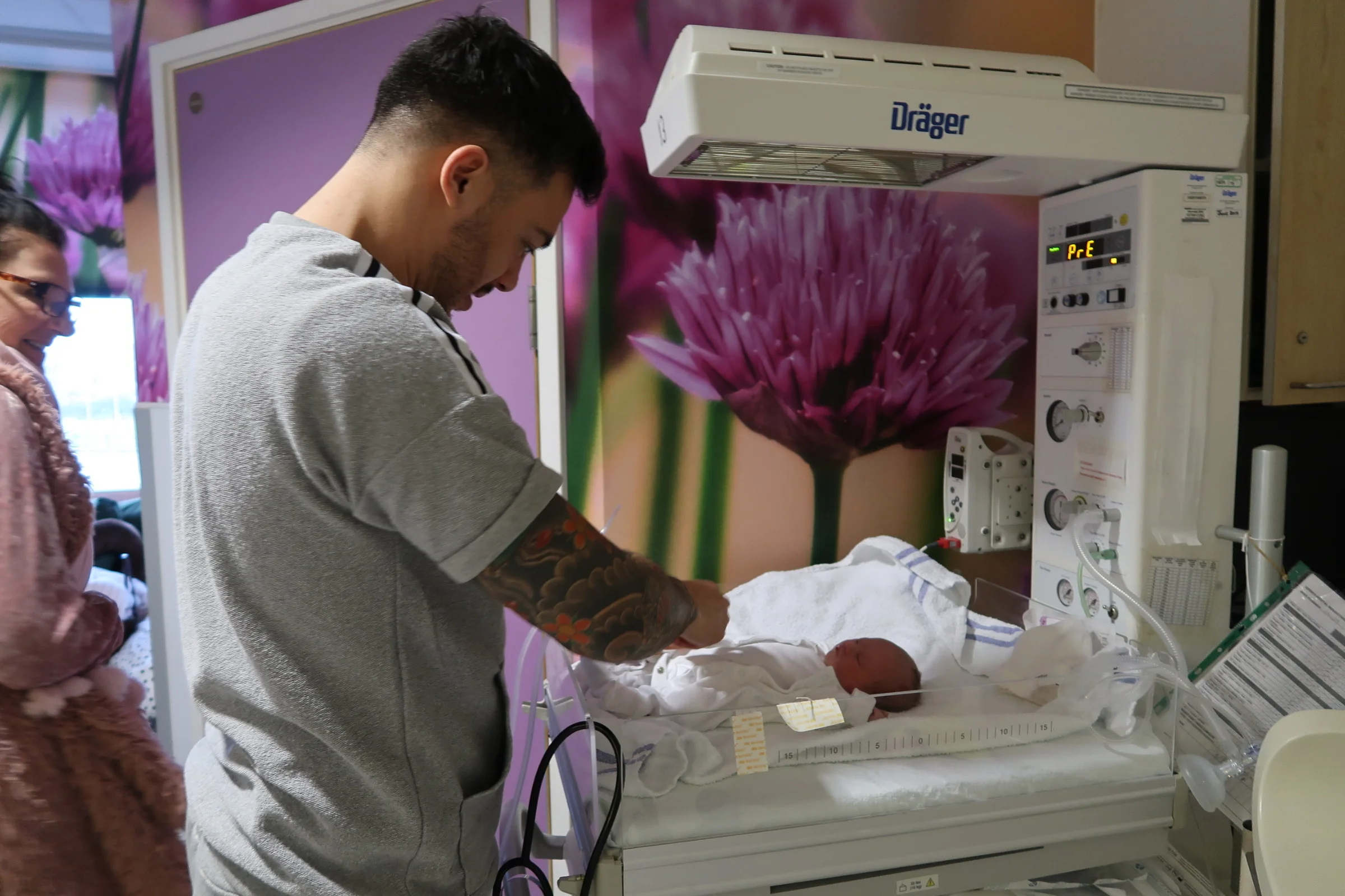 Daddy getting Polly dressed for the first time with the help of Nanny
