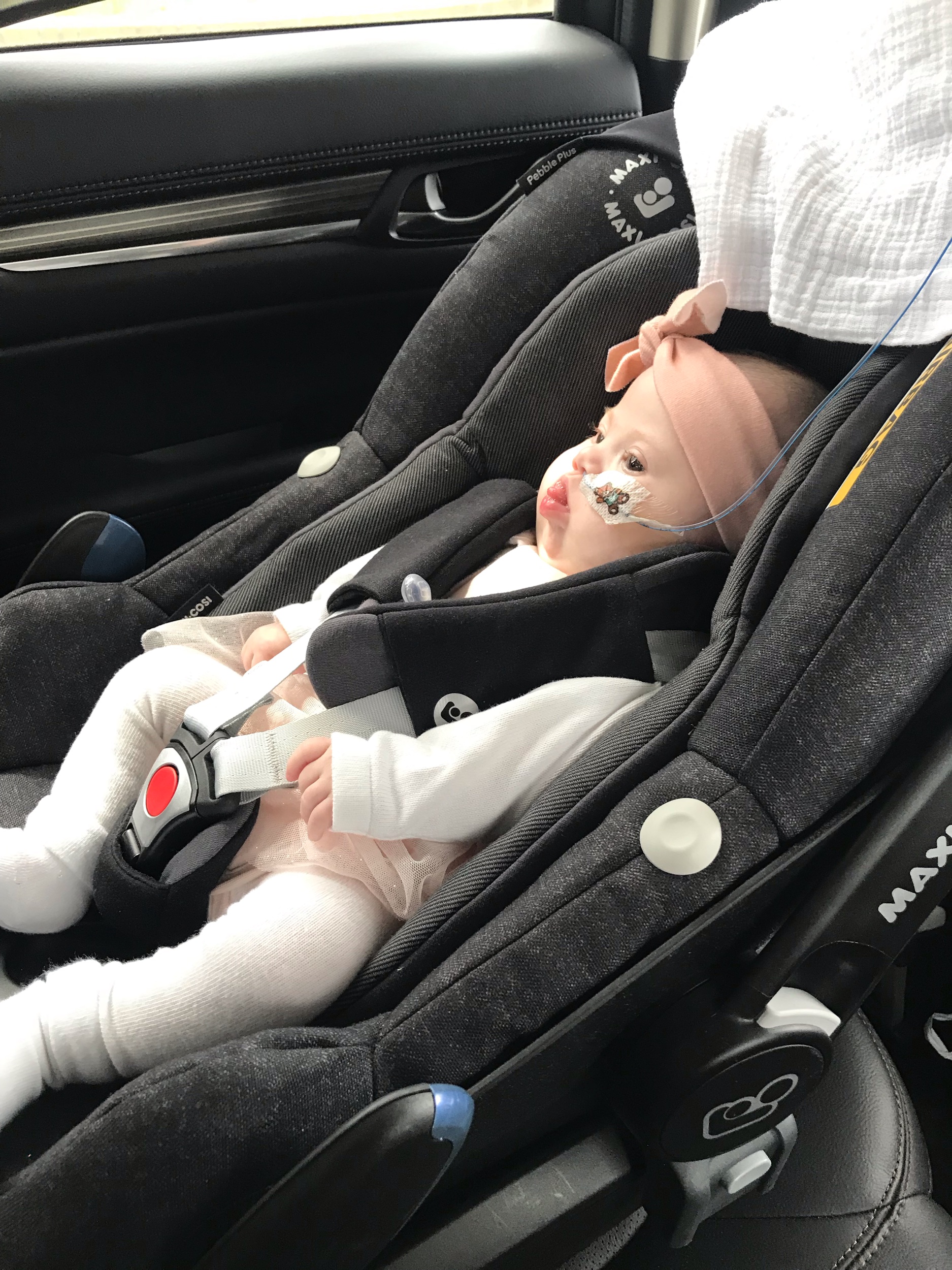 just chilling in her car seat in her new dress and tights ready for dinner at Nanny’s house