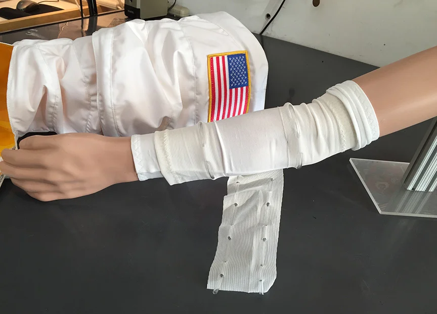 EMU_MuseumDisplay_SpaceSuit_ArmModel_FinalFrontierDesign_CoolingGarment.jpg
