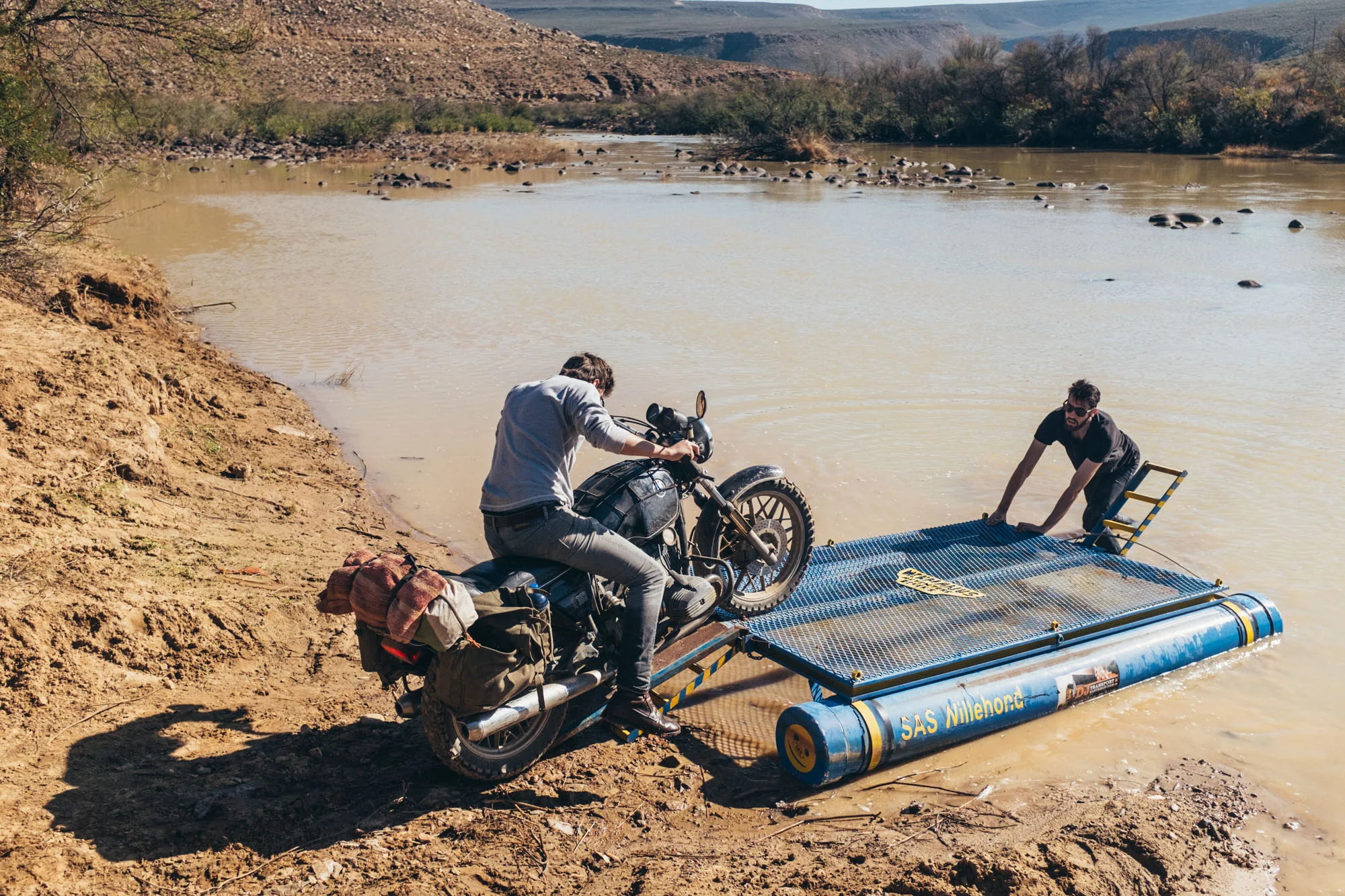 Winter rain had made the Doring River impassable. Luckily, we found a raft on the riverbank with just enough buoyancy to take the bikes across