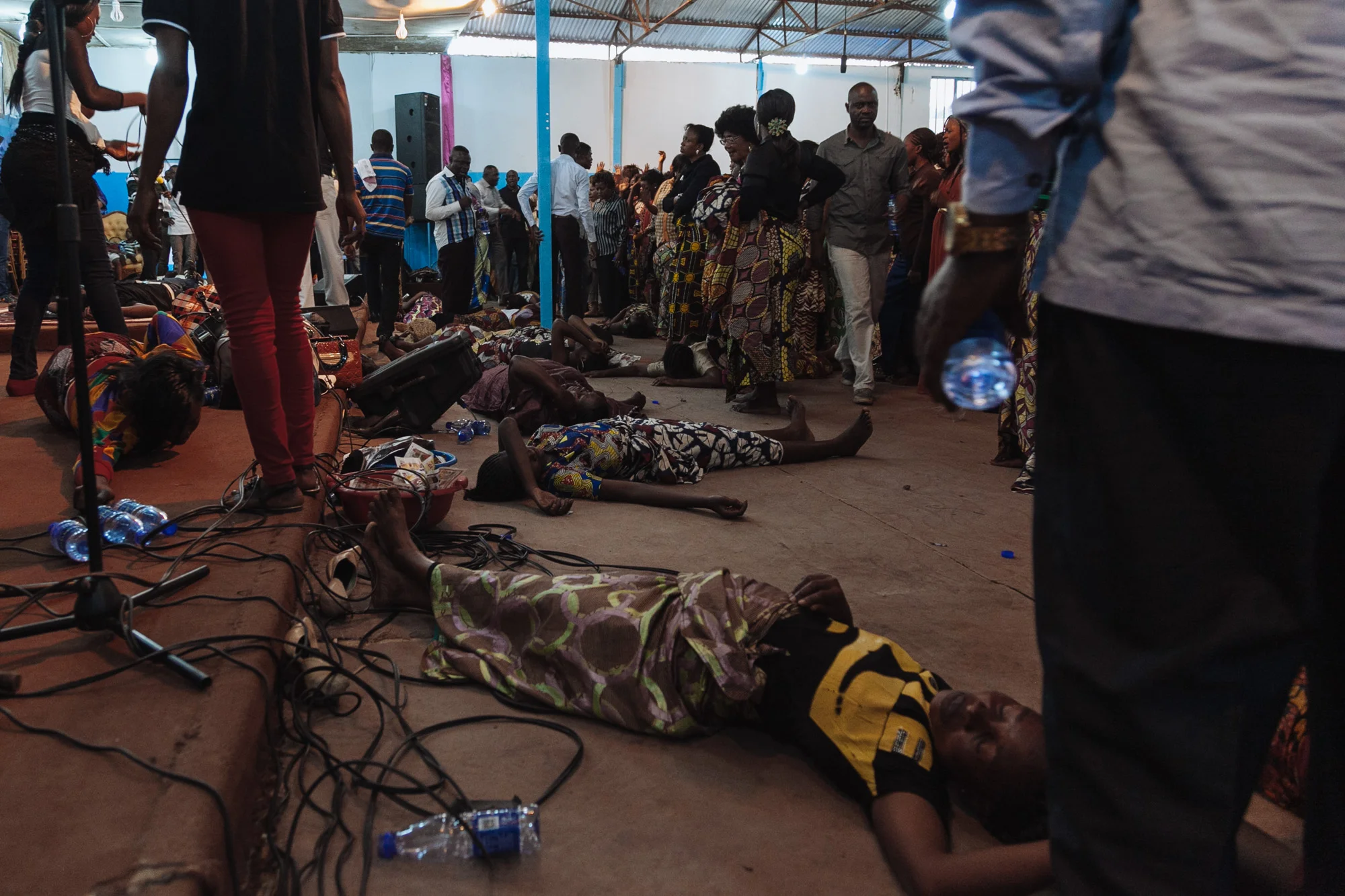 Women lie on the floor of an Evangelical church in Lubumbashi after they fall into uncontrollable fits after believing they have 'caught the holy spirit'.