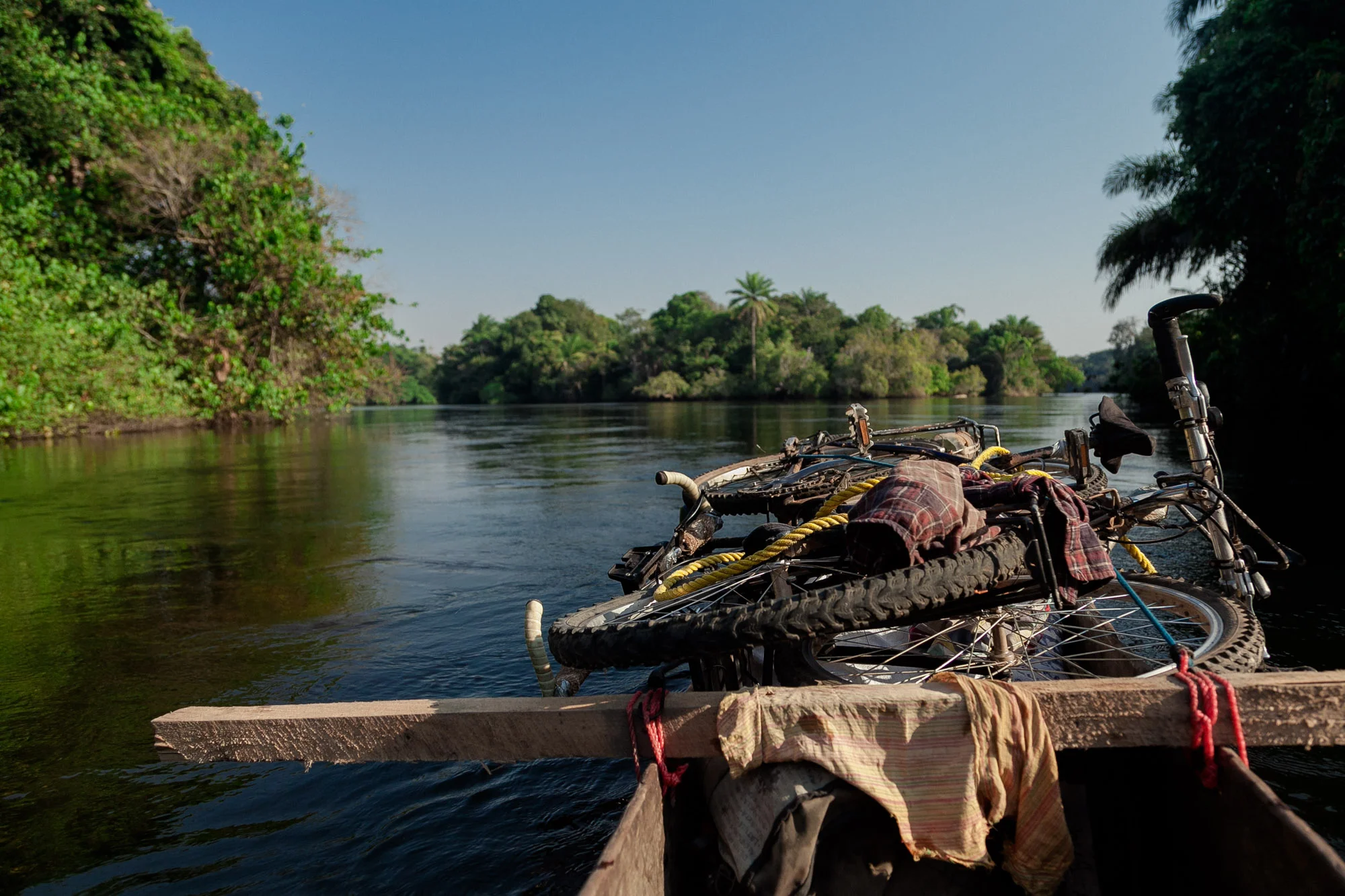 Bicycles onboard on our trusty pirogue that cost us $160 with only a few leaky holes.