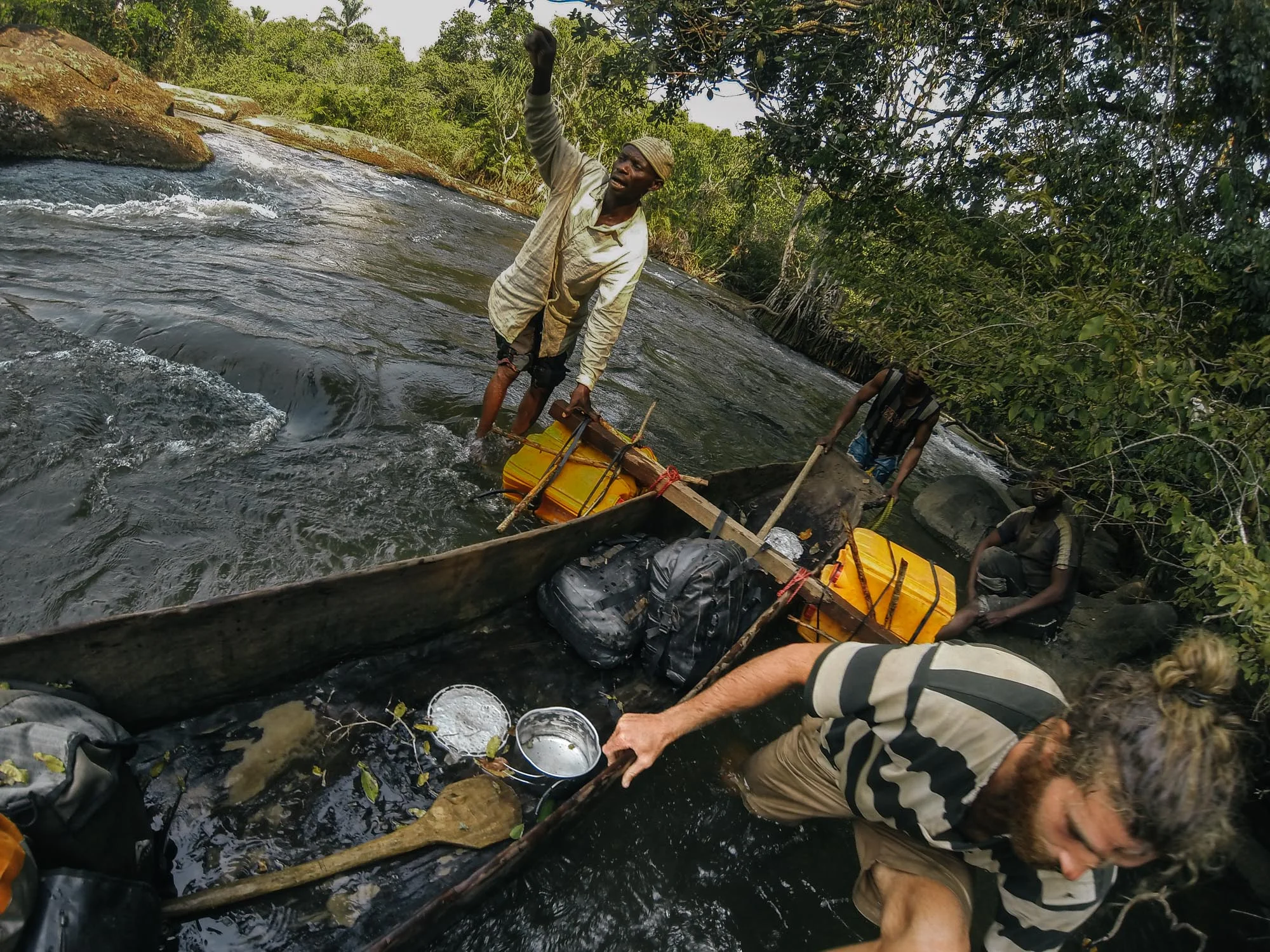 Getting some local assistance tackling the next set of rapids. Our several leaks necessitated hourly bailing sessions in order to keep us afloat and our gear dry.