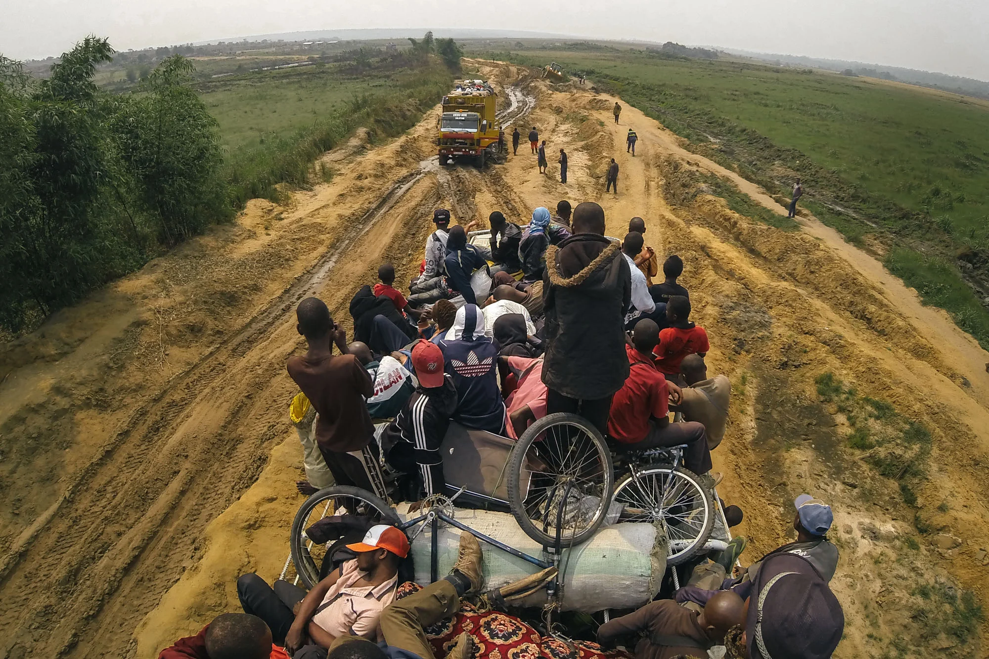 Passengers wait patiently as another truck finds itself thwarted by the treacherous Congo roads.