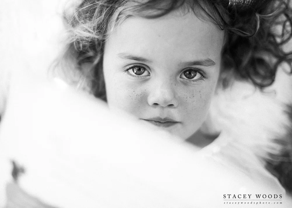Peeping over her books in black and white || Stacey Woods, Florida children's lifestyle photographer