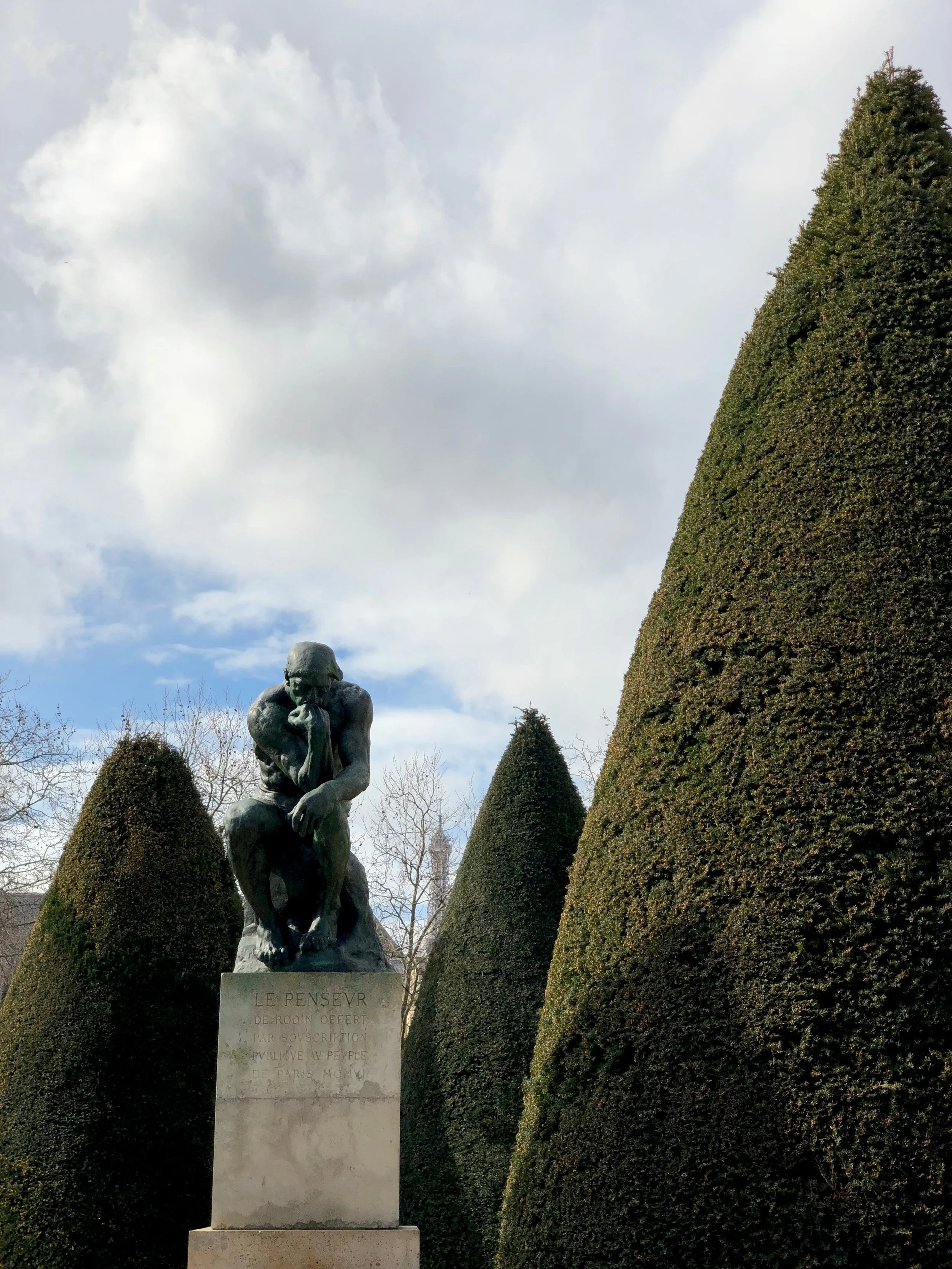 The Thinker, with the Eiffel Tower in the distance.