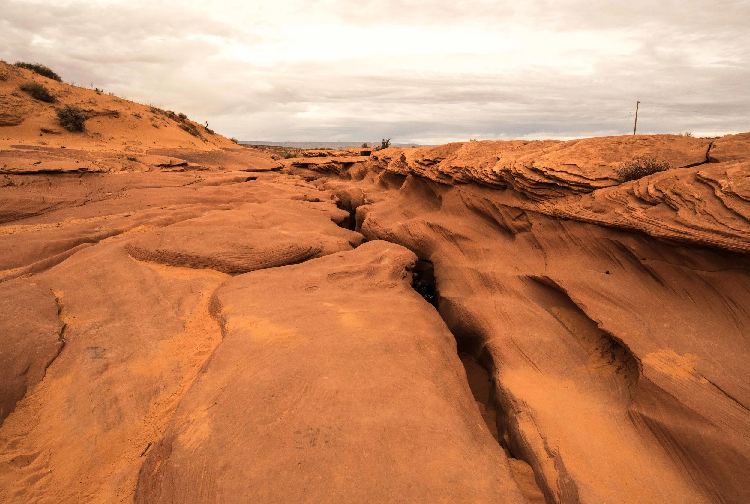 You enter the canyon through cracks in the ground.
