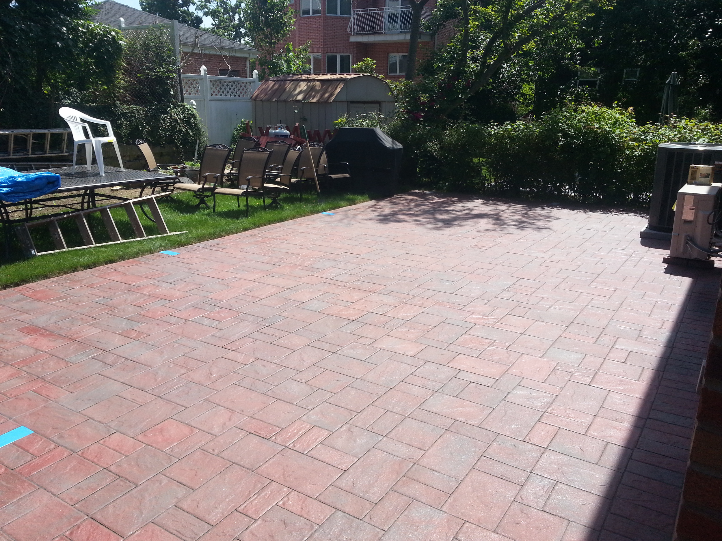 3 piece pavers with locking sand in the joints and a semi gloss sealer. 