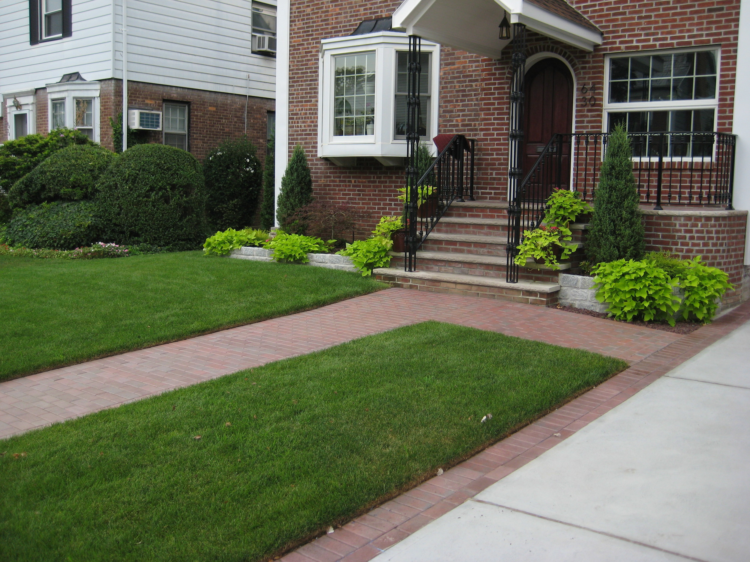 Paver walkway with locking sand in the joints and semi gloss sealer. Concrete driveway. Cobblestone garden walls.