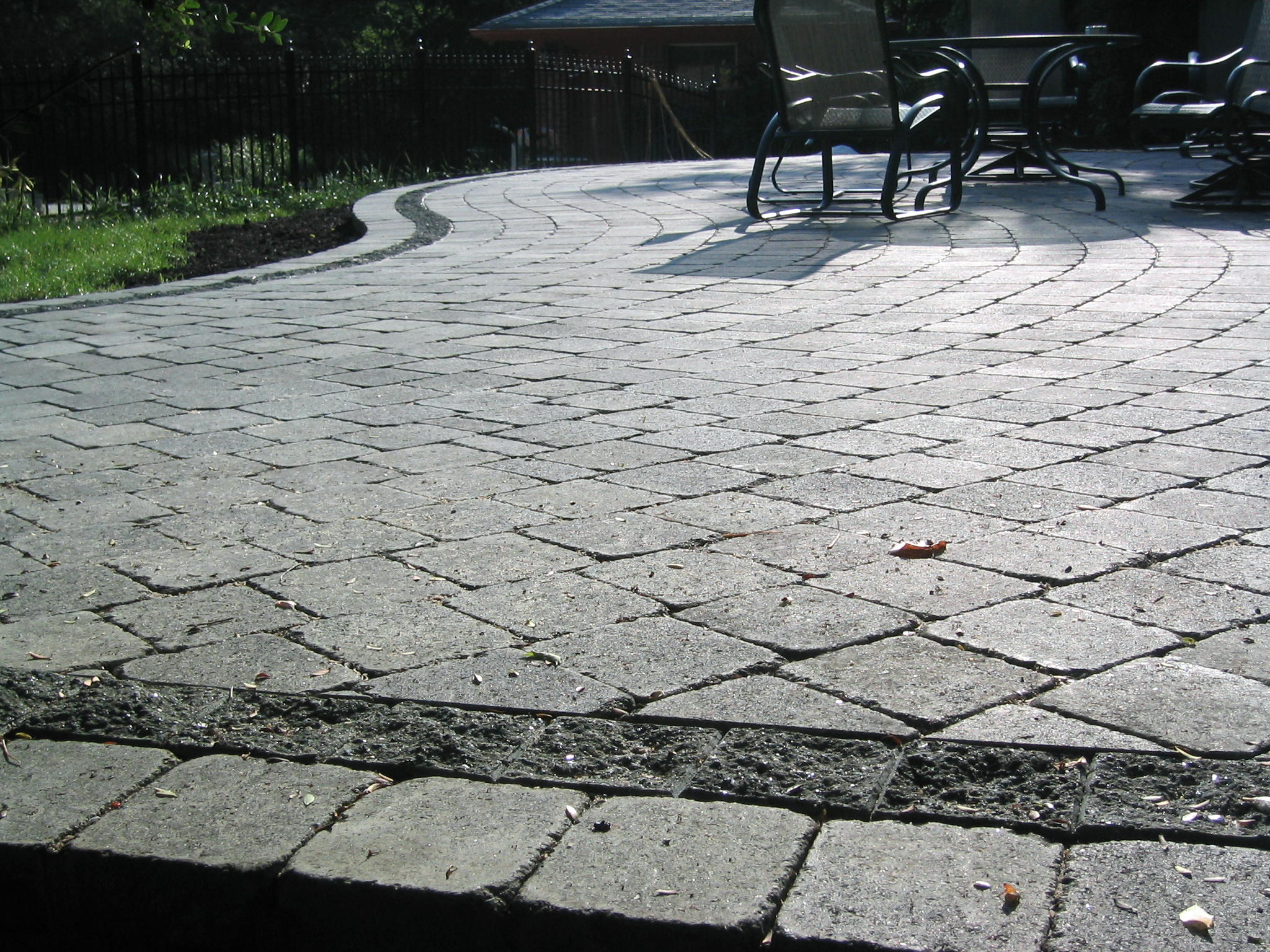 Rustic look pavers with a split face border.