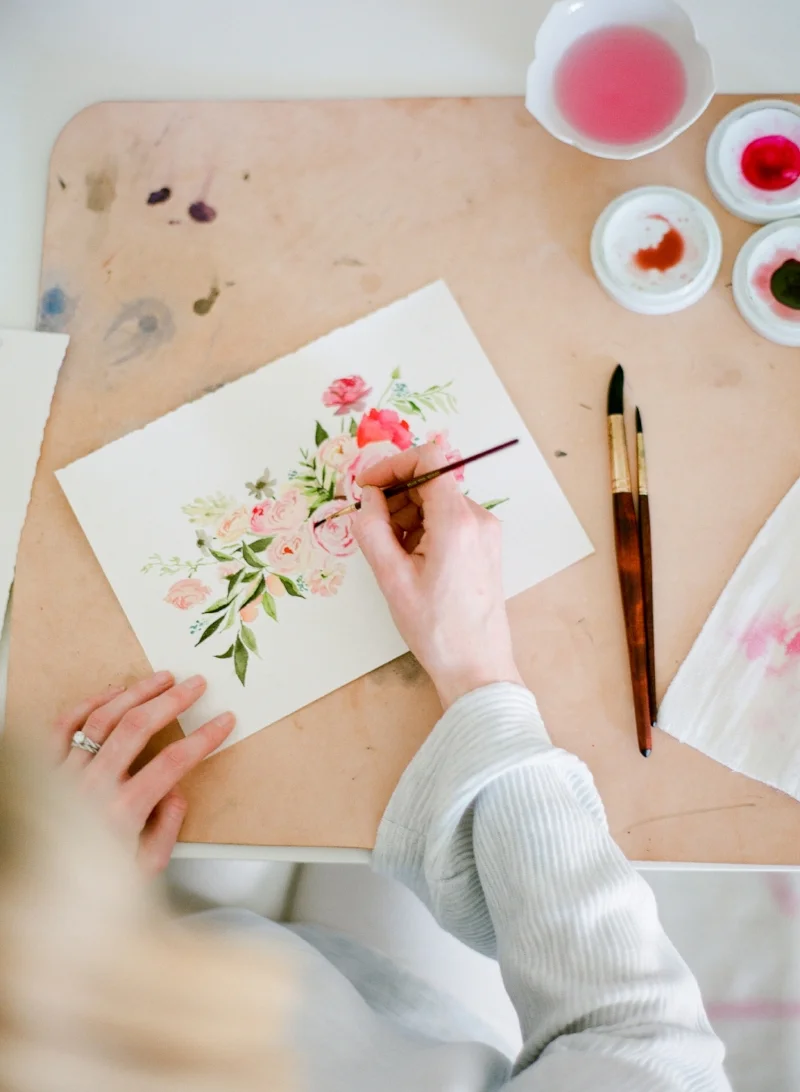 Putting the smallest finishing touches on a watercolor floral piece.