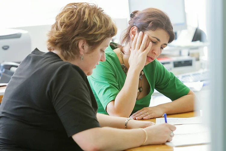 Janelle McKenzie and Lissa Twomey check over a few last details at the Festival Office