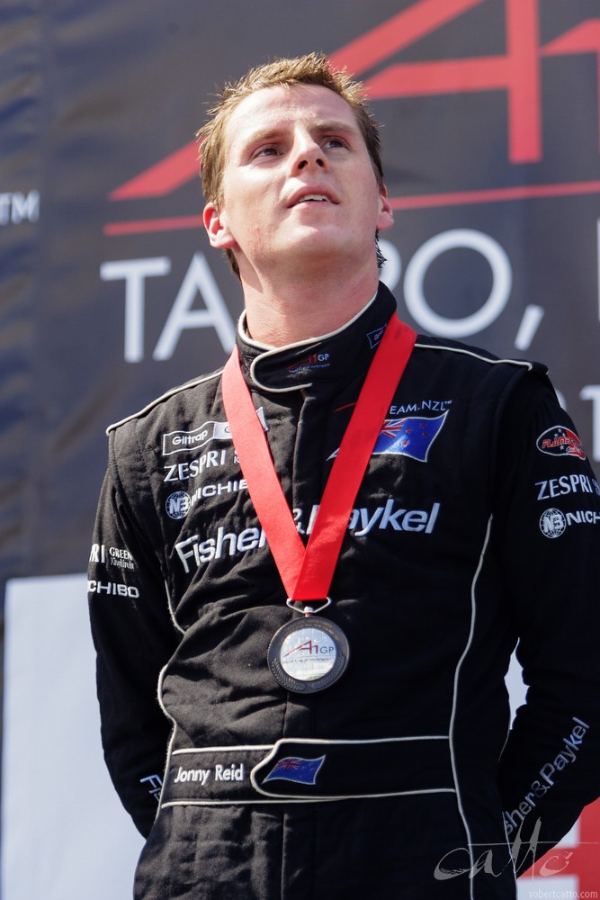 New Zealand driver Jonny Reid on the third step of the podium in Taupo.