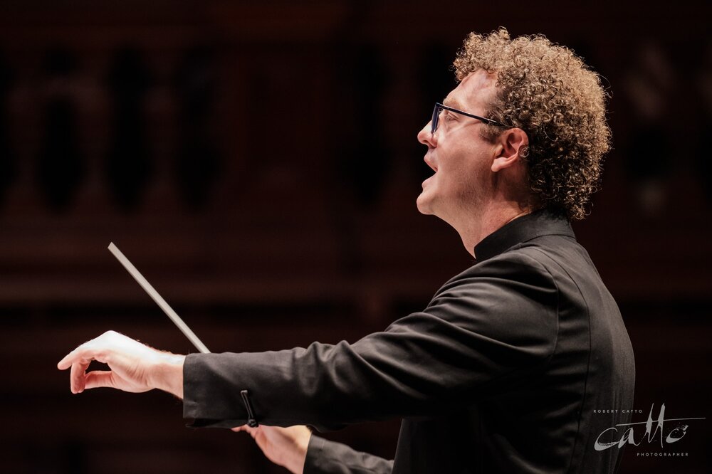  Conductor Brett Weymark leads Sydney Philharmonia Choirs—closeup from side of stage (position 1 on the floor plan). Taken with a Fujifilm X-H1 and 200mm f/2 lens with a 1.4x teleconverter, 1/125s at f/2.8, 3200ISO. 