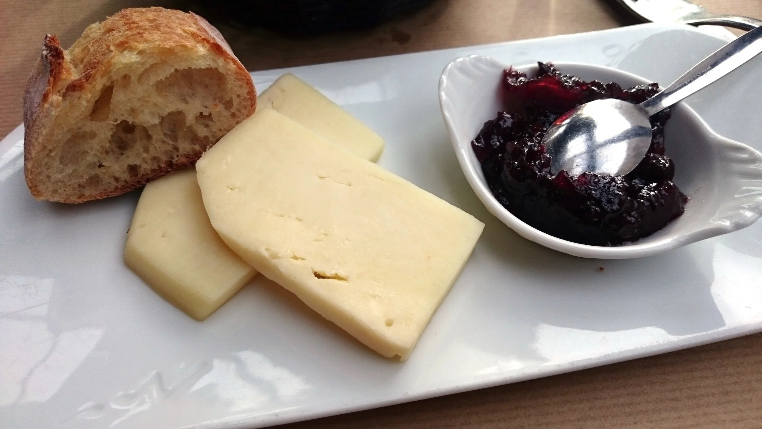 Tomme de brebis , a sheep's cheese from the Southwest of France with the regional condiment of black cherry jam.