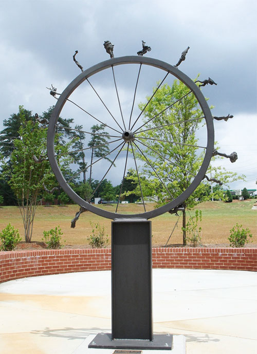 Wheel of Life bronze and painted steel, 8' high (2.5 m). The evolution of technology into increasingly more destructive expressions. Civilization is destroyed. A new civilization rises from the ashes. The karmic cycle continues. 