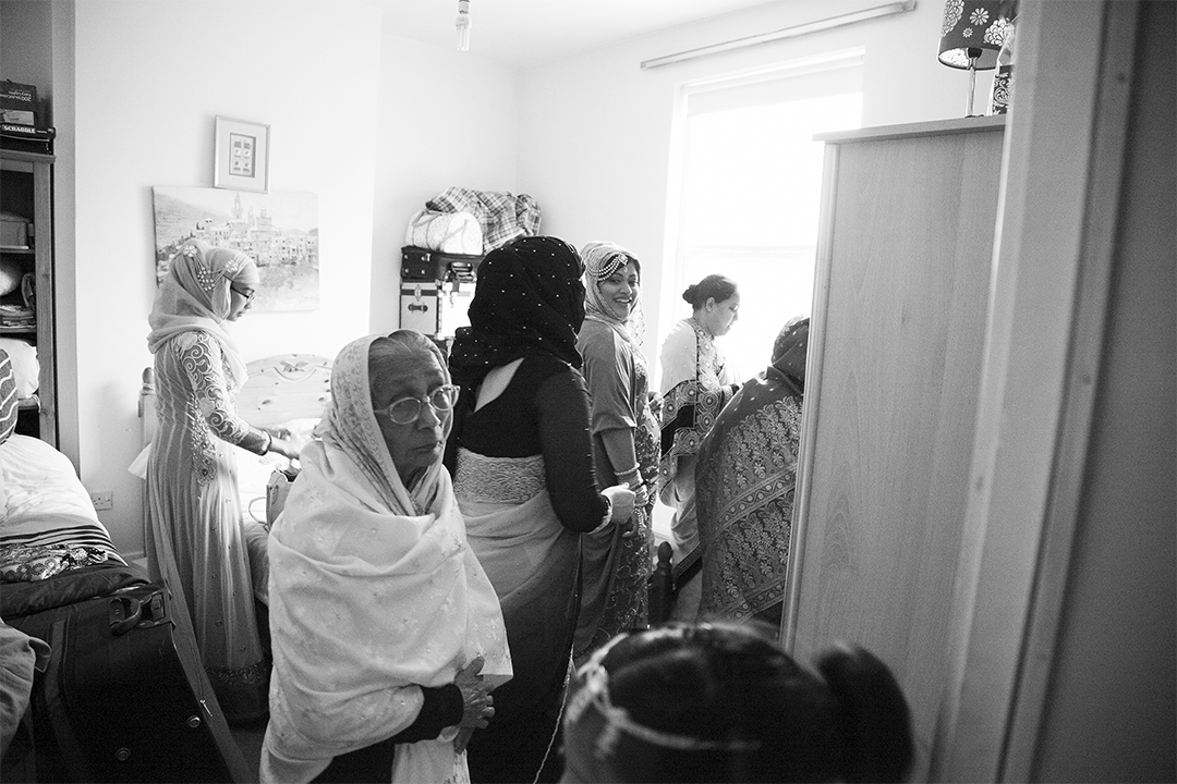 The Bedroom The main bedroom is filled with women, helping one another dress and prepare with make-up and accessories. 