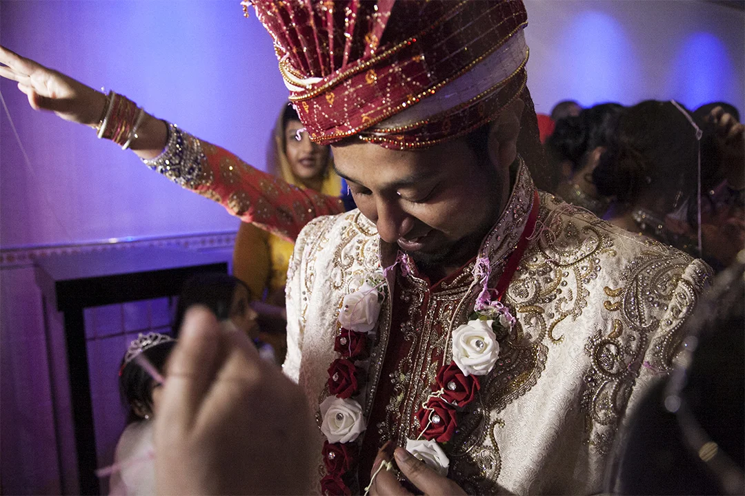 The Groom Prepares to Enter Covered in silly string, the grooms family prepare him to enter the wedding hall, where the Nikah will take place.