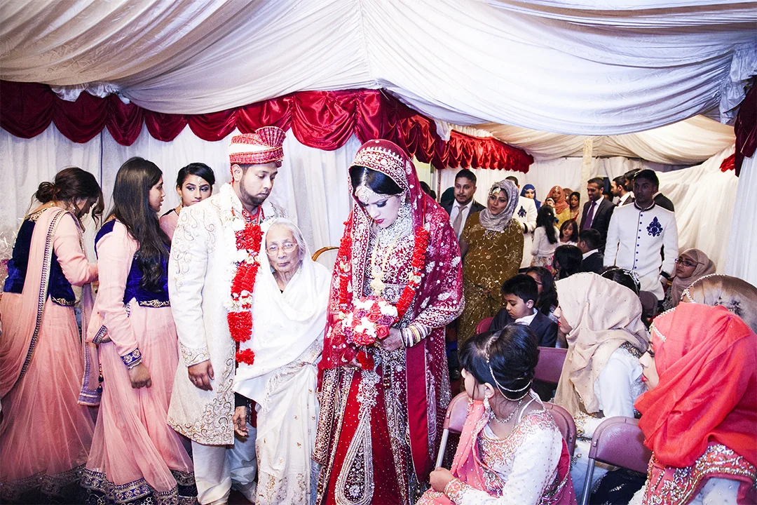 Her New Home The bride arrives at the groom's house where a marquee is placed in the back garden. Close family of the groom await the couple. The bride and groom receive mouthfuls of food from each family member over the course of two to three hours.